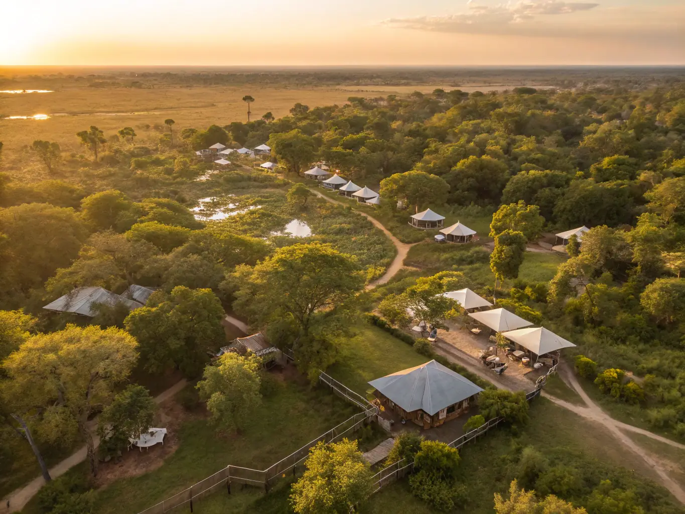 A stunning aerial view of a safari lodge nestled in the African wilderness, emphasizing the unique experiences offered to guests.